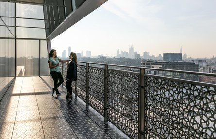 Two girls standing at the Aga Khan Centre Terrace of Discovery