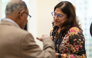 Dr. Laila Halani speaking to an IIS representative during the welcome lunch event 2023